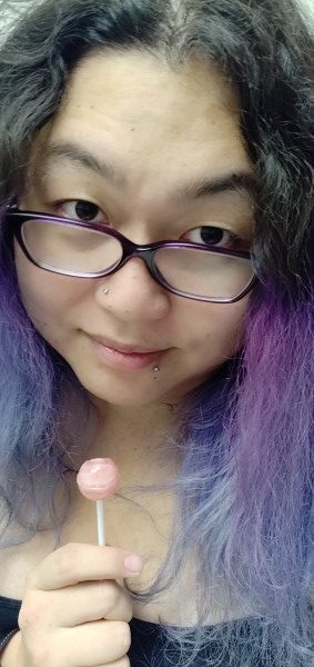 Sophia Lee with purple hair and lolipop